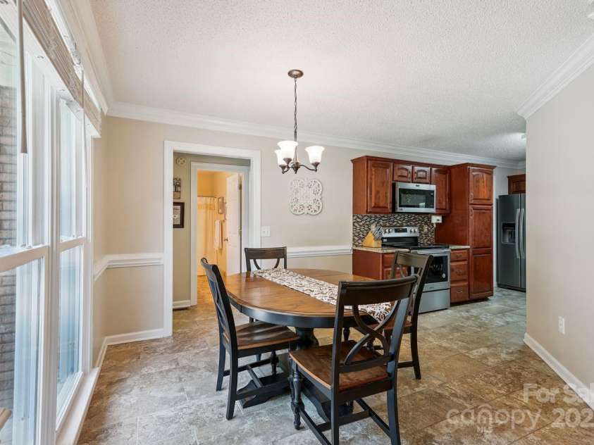 8300 Quail Hollow Drive, Harrisburg, NC 28075.  MLS# CAR4295062, YatesRealty ID 34726. Breakfast room overlooking back yard.
