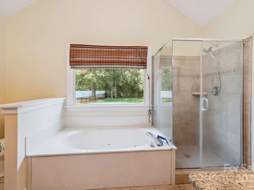 8300 Quail Hollow Drive, Harrisburg, NC 28075.  MLS# CAR4295062, YatesRealty ID 34726. Garden tub in primary bedroom.