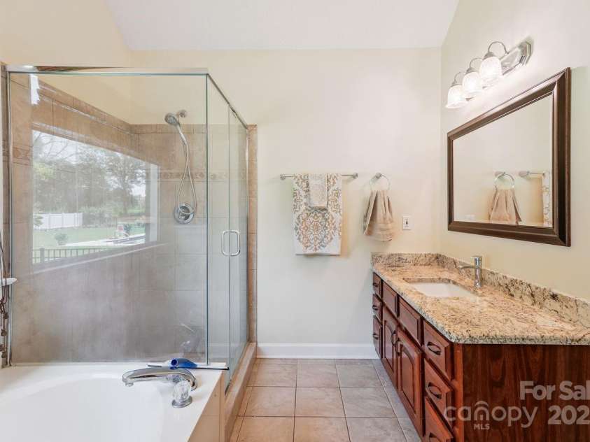 8300 Quail Hollow Drive, Harrisburg, NC 28075.  MLS# CAR4295062, YatesRealty ID 34726. Primary bathroom.