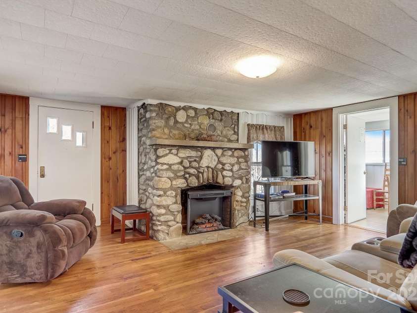 1639 Soco Road, Maggie Valley, NC 28751.  MLS# CAR4214024, YatesRealty ID 3473. Rock fireplace with elec insert