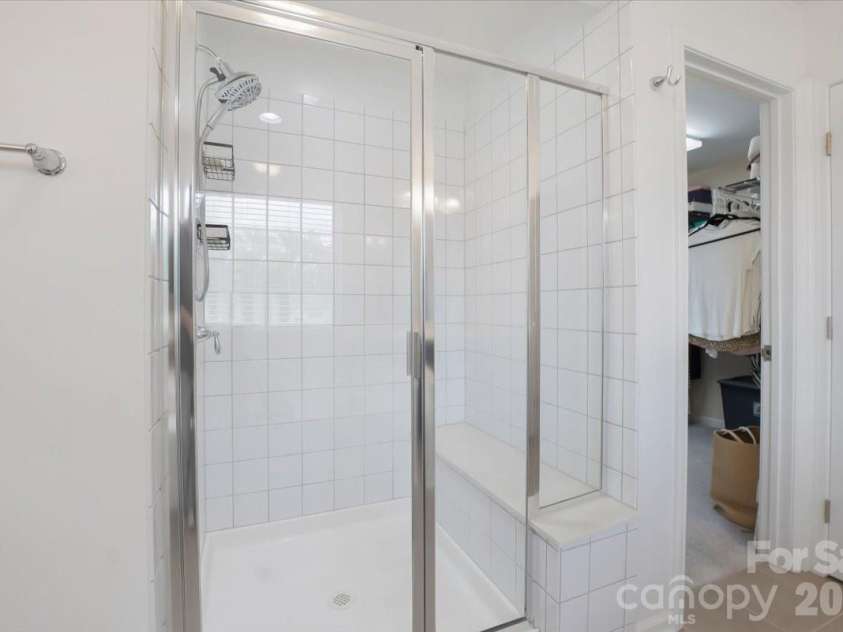 17534 Austins Creek Drive, Charlotte, NC 28278.  MLS# CAR4388620, YatesRealty ID 34731. Beautiful tile. Built-in seat. A shower that understands the difference between getting clean and actually unwinding — and delivers both without being asked.