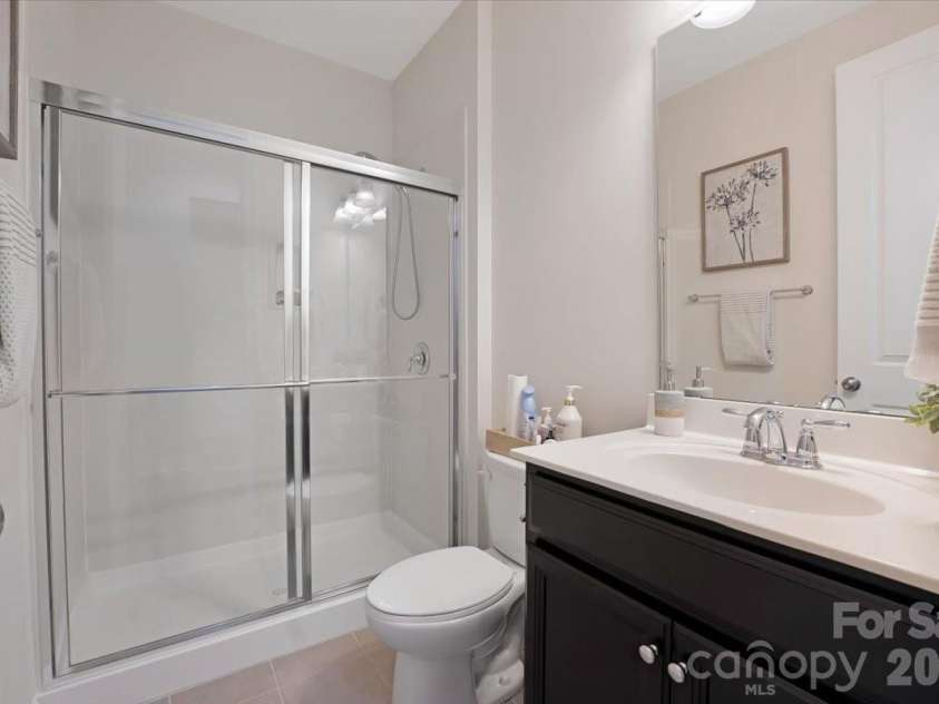 17534 Austins Creek Drive, Charlotte, NC 28278.  MLS# CAR4388620, YatesRealty ID 34731. Full bath. Walk-in shower. Main level. Everything your guests need and everything a multi-generational floor plan demands — right where it belongs.
