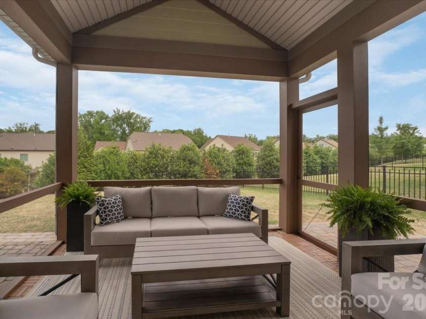 17534 Austins Creek Drive, Charlotte, NC 28278.  MLS# CAR4388620, YatesRealty ID 34731. Same great screened porch. New angle. Vaulted ceiling that makes the whole space soar. This is outdoor living done with intention — and it shows from every direction you look at it.