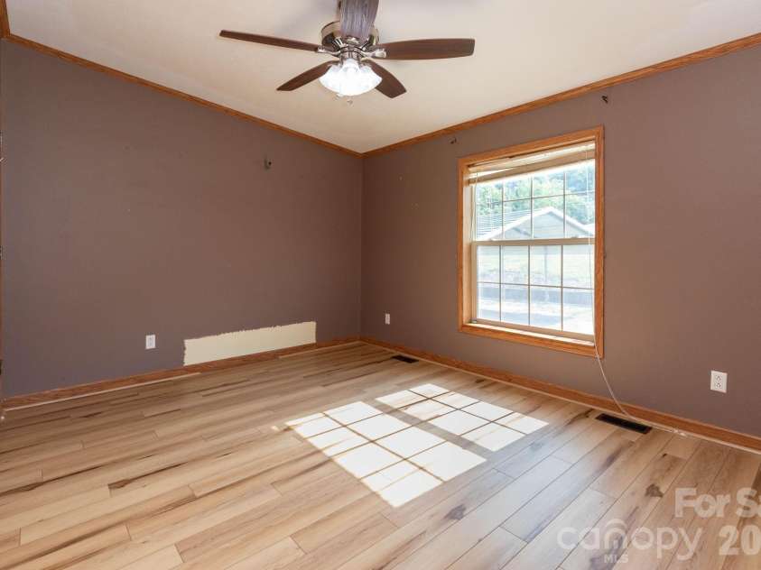 71 Teachers Lane, Canton, NC 28716.  MLS# CAR4394186, YatesRealty ID 34734. Additional spacious bedroom with updated flooring, ceiling fan, and ample closet space.
