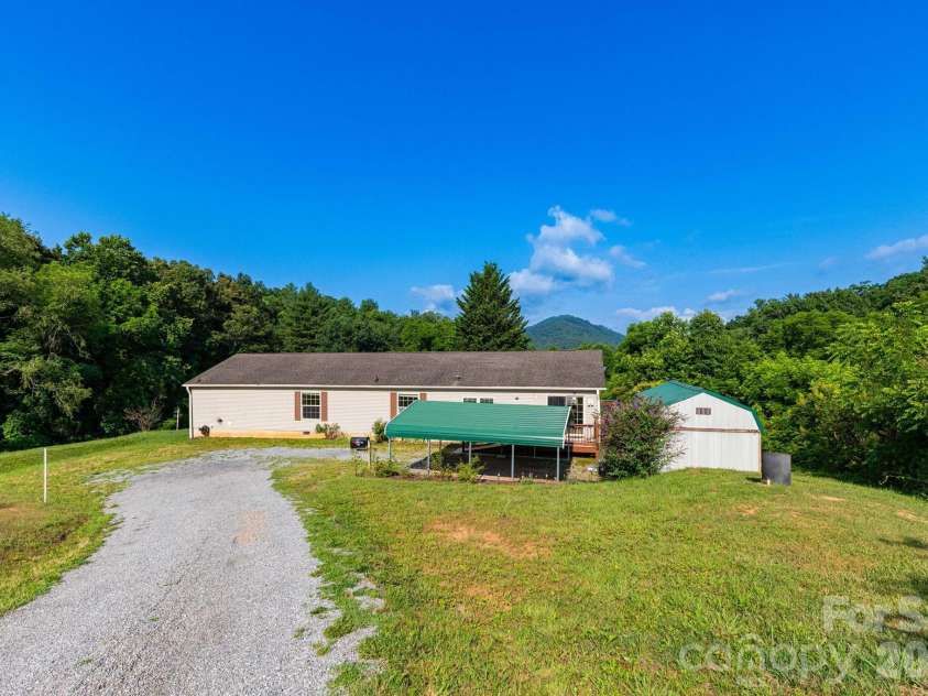 71 Teachers Lane, Canton, NC 28716.  MLS# CAR4394186, YatesRealty ID 34734. Front exterior showcasing the spacious home, mountain views, and private setting.