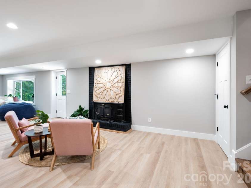 15 Pine Ridge Court, Fletcher, NC 28732.  MLS# CAR4338257, YatesRealty ID 34739. Second Wood Stove Fireplace in Lower Level Basement