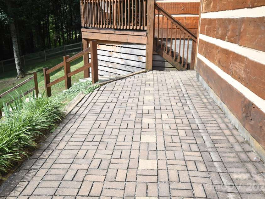 120 Spotted Fawn Lane, Waynesville, NC 28785.  MLS# CAR4284528, YatesRealty ID 34742. Brick pavers beside the garage to the front deck of the home