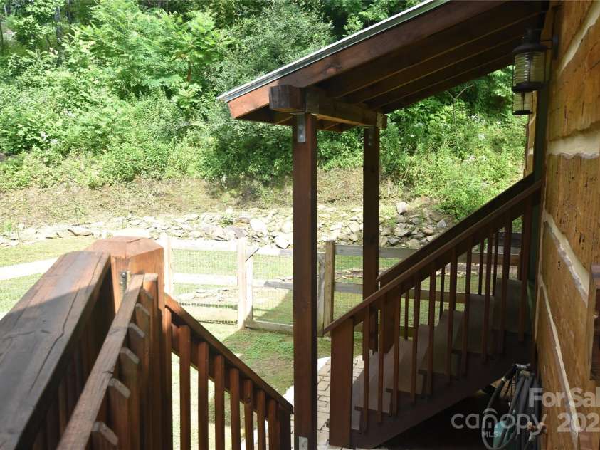 120 Spotted Fawn Lane, Waynesville, NC 28785.  MLS# CAR4284528, YatesRealty ID 34742. Cover and stairs over the side door to the great room