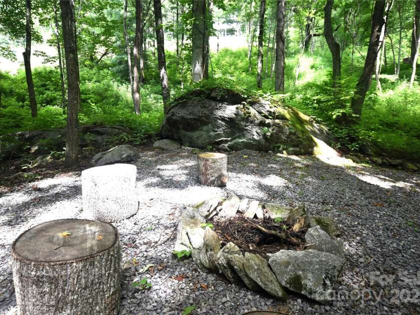 120 Spotted Fawn Lane, Waynesville, NC 28785.  MLS# CAR4284528, YatesRealty ID 34742. Large Boulder by the firepit