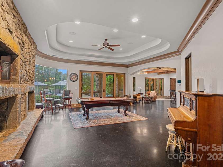 6821 Pebble Bay Drive, Denver, NC 28037.  MLS# CAR4292691, YatesRealty ID 34754. Billiards room in the basement overlooking the pool terrace.