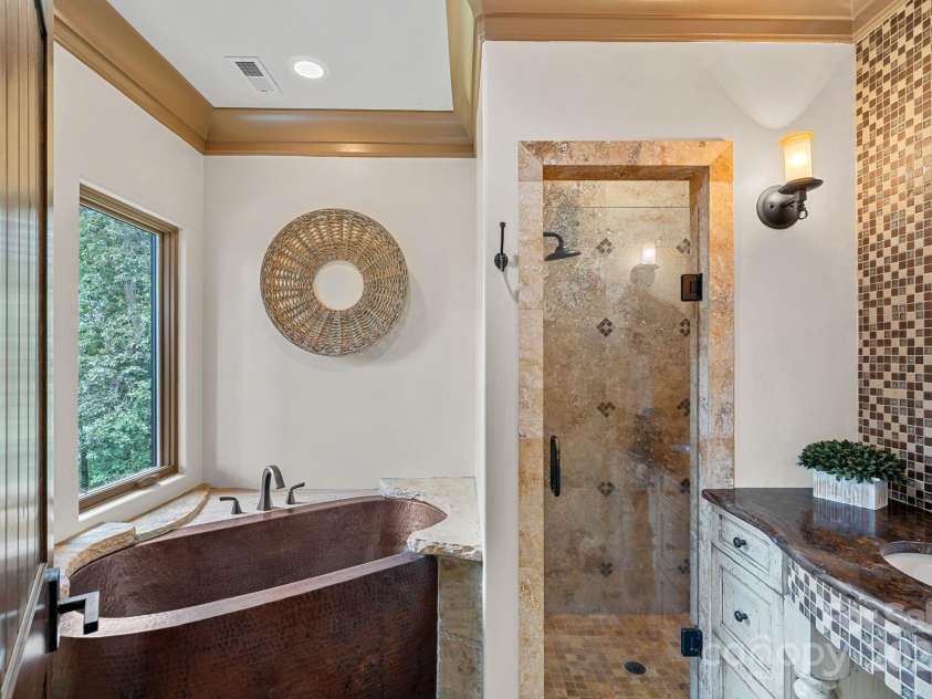 6821 Pebble Bay Drive, Denver, NC 28037.  MLS# CAR4292691, YatesRealty ID 34754. Secondary bedroom suite bath with a copper soaking tub and a walk-in shower.