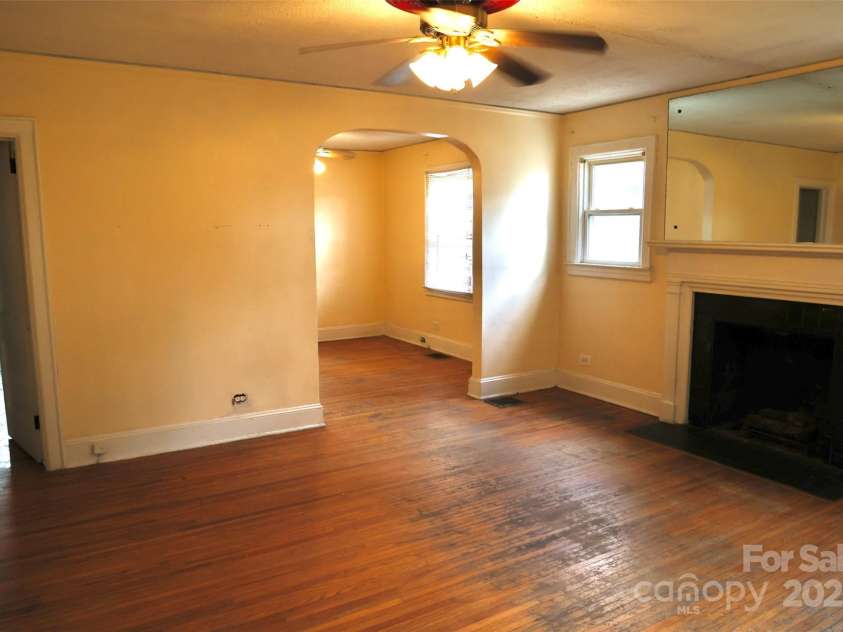 2629 Commonwealth Avenue, Charlotte, NC 28205.  MLS# CAR4295846, YatesRealty ID 34761. Living room looking into dining room and hallway