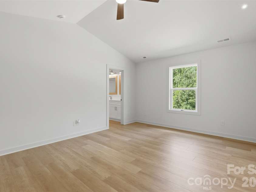 9472 Caddell Road, Fort Mill, SC 29707.  MLS# CAR4389015, YatesRealty ID 34780. Primary bedroom with vaulted ceilings