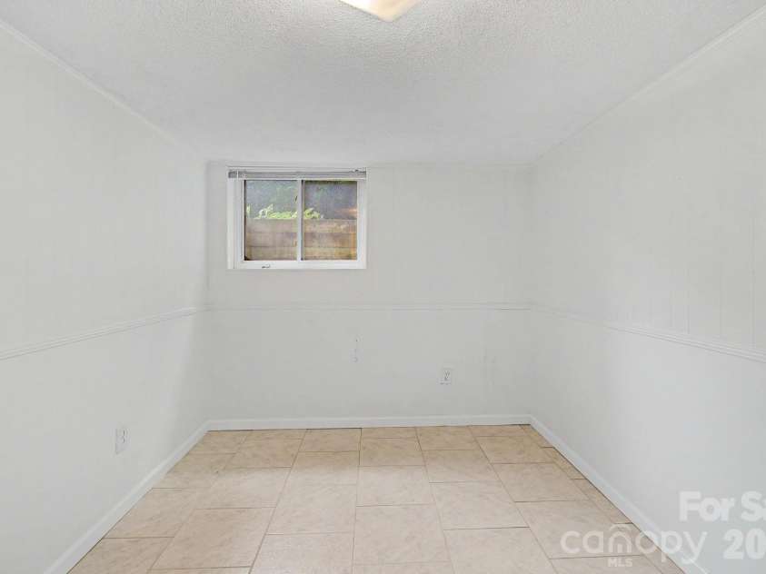 22 Mayfair Drive, Candler, NC 28715.  MLS# CAR4391102, YatesRealty ID 34782. Basement room