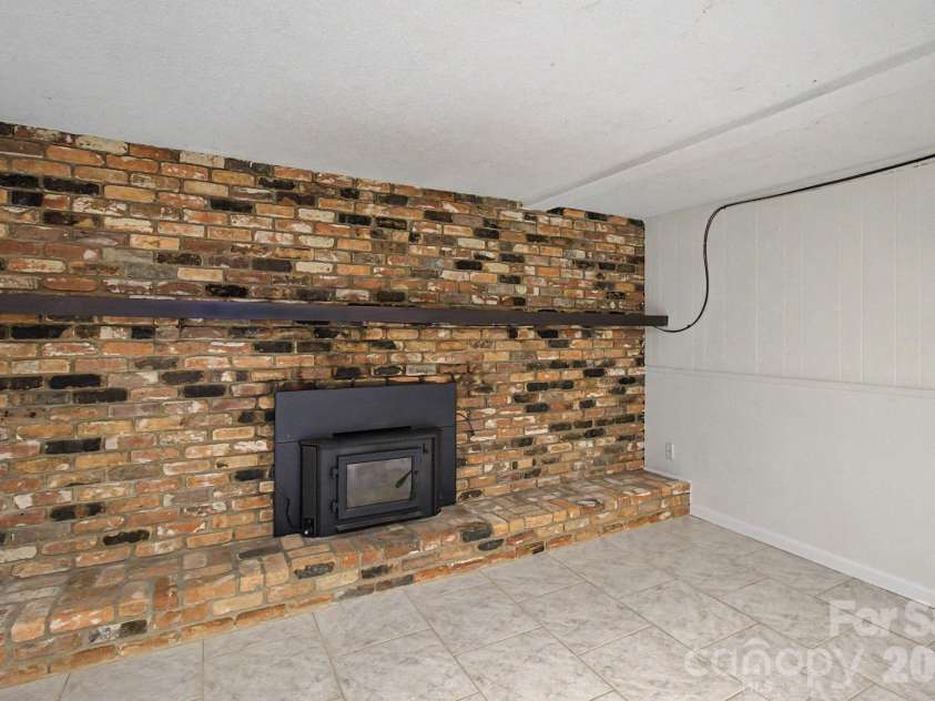 22 Mayfair Drive, Candler, NC 28715.  MLS# CAR4391102, YatesRealty ID 34782. Fireplace in lower Recreation room