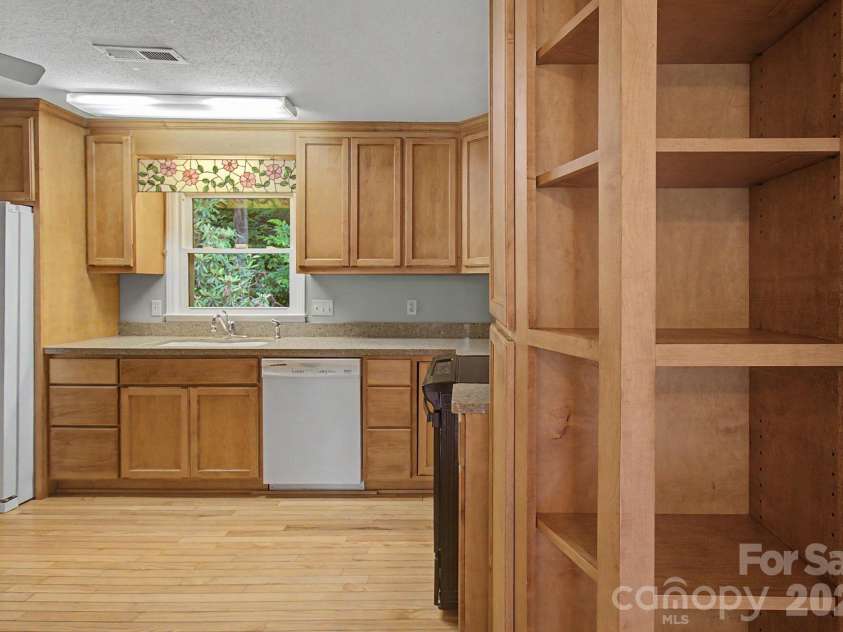 22 Mayfair Drive, Candler, NC 28715.  MLS# CAR4391102, YatesRealty ID 34782. Kitchen Area with Storage