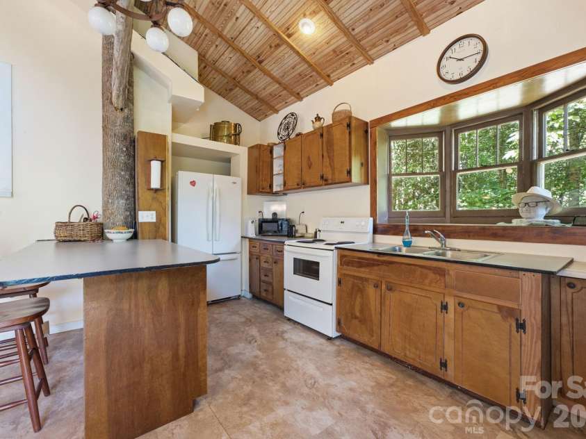 583 Dark Ridge Road, Sylva, NC 28779.  MLS# CAR4394353, YatesRealty ID 34785. Kitchen features wood cabinets and ceiling and large bay window