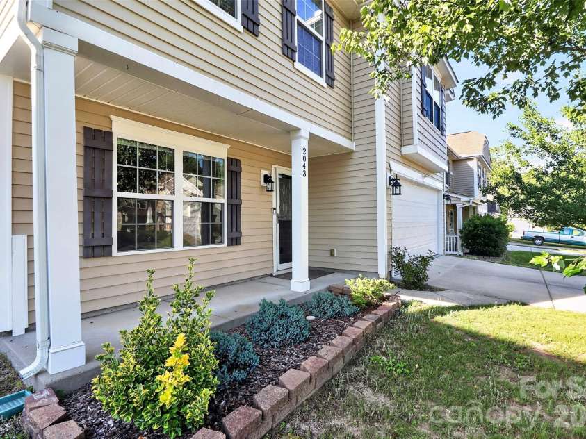 2043 Grimley Lane, Fort Mill, SC 29707.  MLS# CAR4397584, YatesRealty ID 34788. Front porch and flower bed