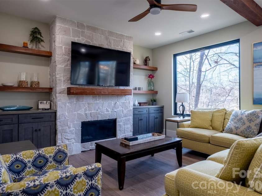 150 Driftwood Drive, Mooresville, NC 28117.  MLS# CAR4347093, YatesRealty ID 3480. Living space with large windows, linear fireplace