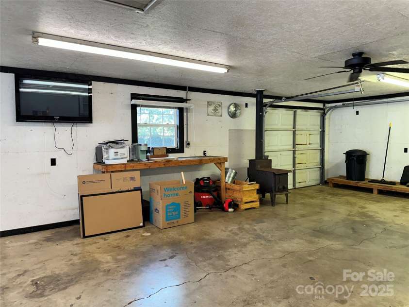 706 Sides Street, Rockwell, NC 28138.  MLS# CAR4283920, YatesRealty ID 34813. Garage equipped with woodstove, fans, lights and benches