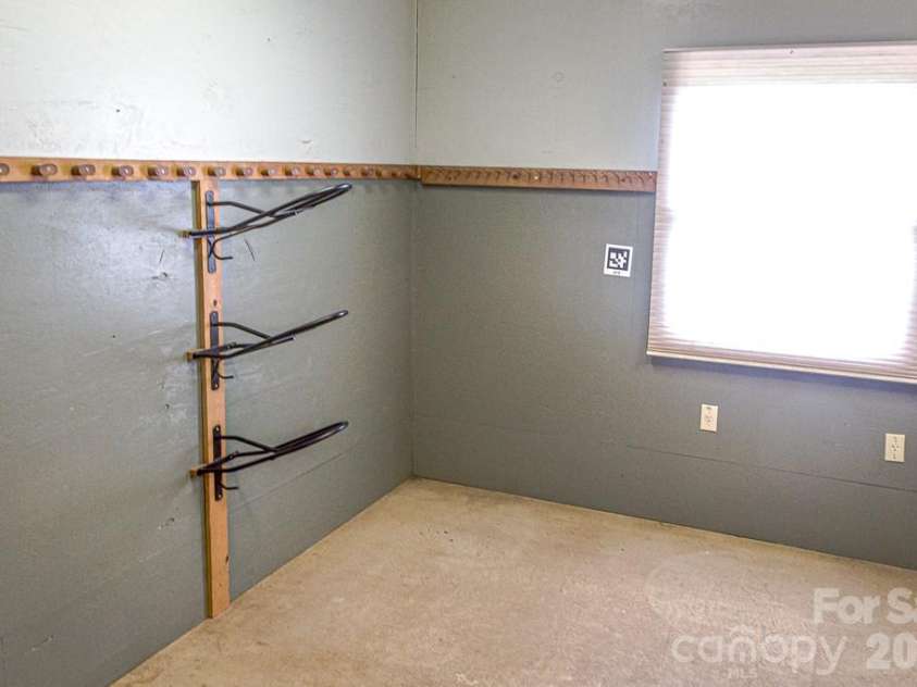711 Meadow Crest Road, Tryon, NC 28782.  MLS# CAR4399879, YatesRealty ID 34861. Large tack room with concrete floor.