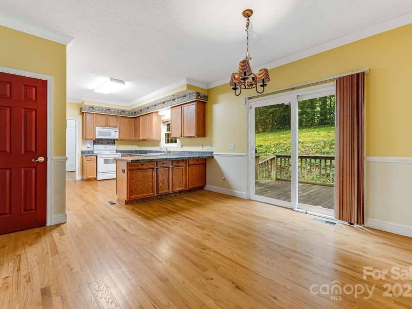 163 Terrace Field Trail, Flat Rock, NC 28731.  MLS# CAR4295496, YatesRealty ID 34865. Kitchen and dining area with hardwood floors.