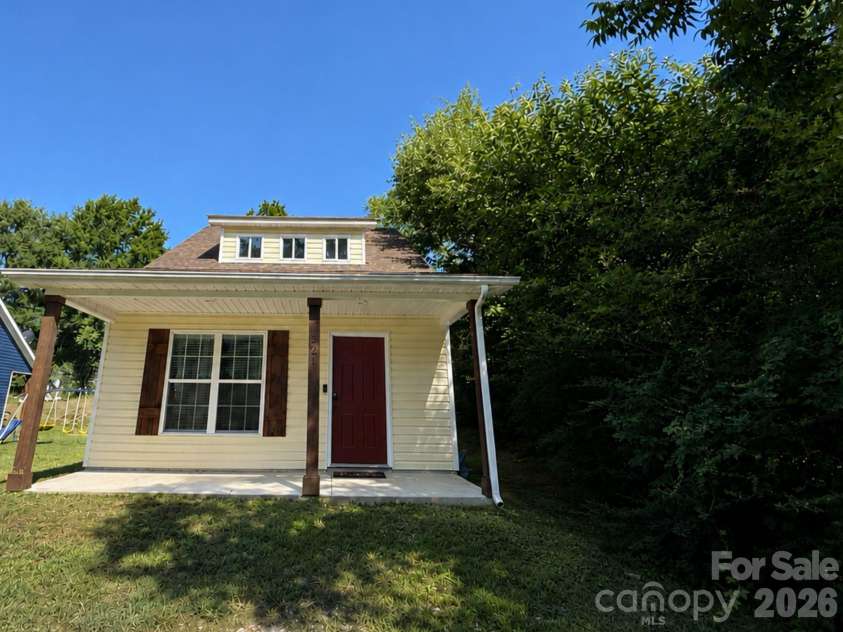 521 Johnson Street, Chester, SC 29706.  MLS# CAR4400310, YatesRealty ID 34869. Front Exterior – Charming front façade with a spacious covered porch, mature surrounding trees, and an inviting entrance that creates a warm first impression.