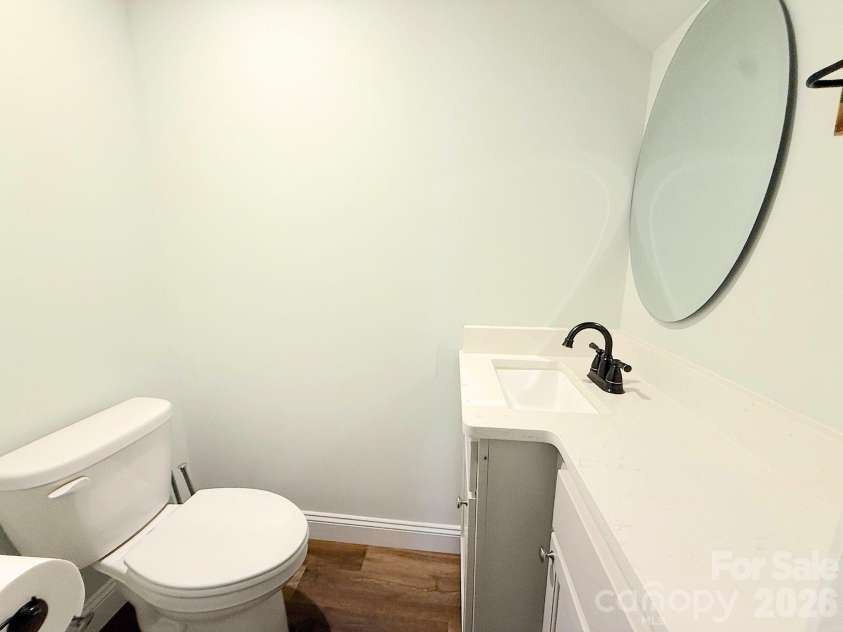 521 Johnson Street, Chester, SC 29706.  MLS# CAR4400310, YatesRealty ID 34869. Powder Room – Convenient main-level half bath featuring a modern vanity with solid-surface countertop, updated fixtures, and a contemporary round mirror.