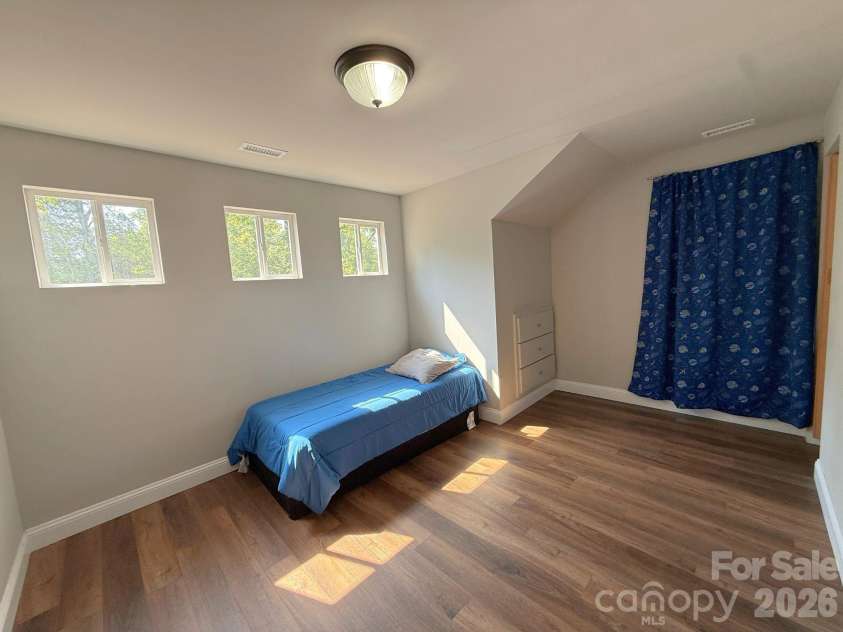 521 Johnson Street, Chester, SC 29706.  MLS# CAR4400310, YatesRealty ID 34869. Upstairs Bedroom – Large secondary bedroom with abundant natural light, luxury vinyl plank flooring, and versatile space to accommodate a variety of needs.