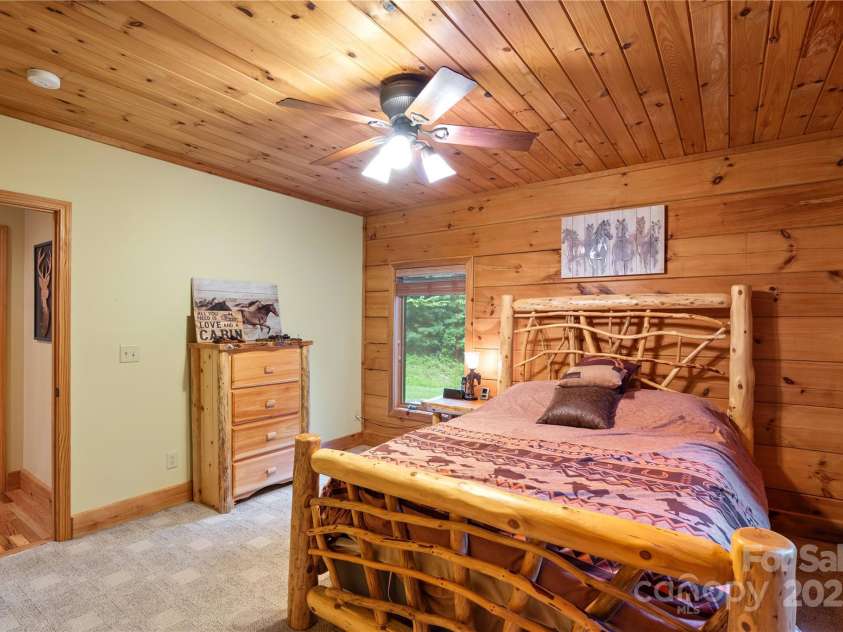 12215 Big Laurel Road, Marshall, NC 28753.  MLS# CAR4289922, YatesRealty ID 34872. Main level guest bedroom with tongue and groove ceilings