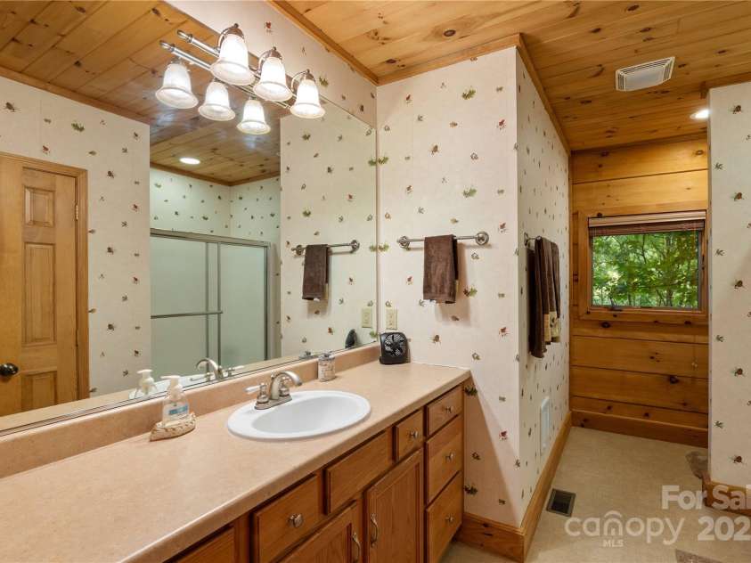 12215 Big Laurel Road, Marshall, NC 28753.  MLS# CAR4289922, YatesRealty ID 34872. Main level guest full bath with oversized sink and tub/shower combo