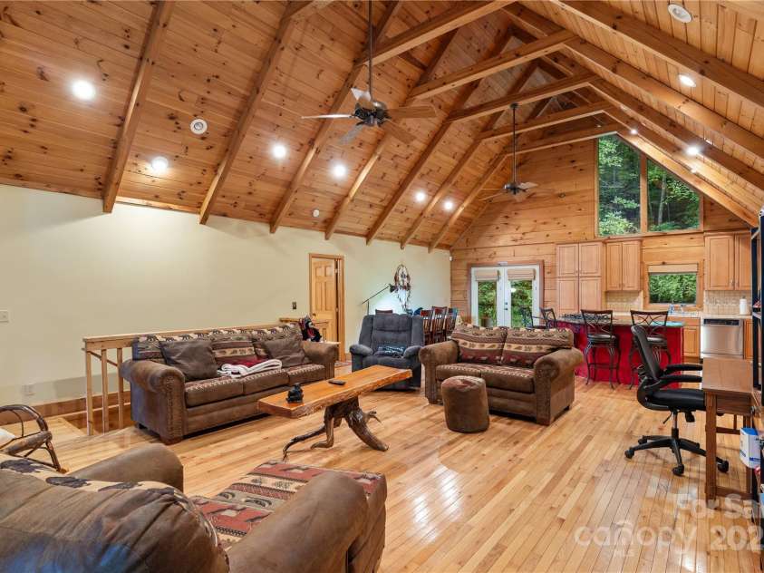 12215 Big Laurel Road, Marshall, NC 28753.  MLS# CAR4289922, YatesRealty ID 34872. Open concept living room with 19' ceilings, post and beam construction, hardwood floors and tongue and groove ceilings