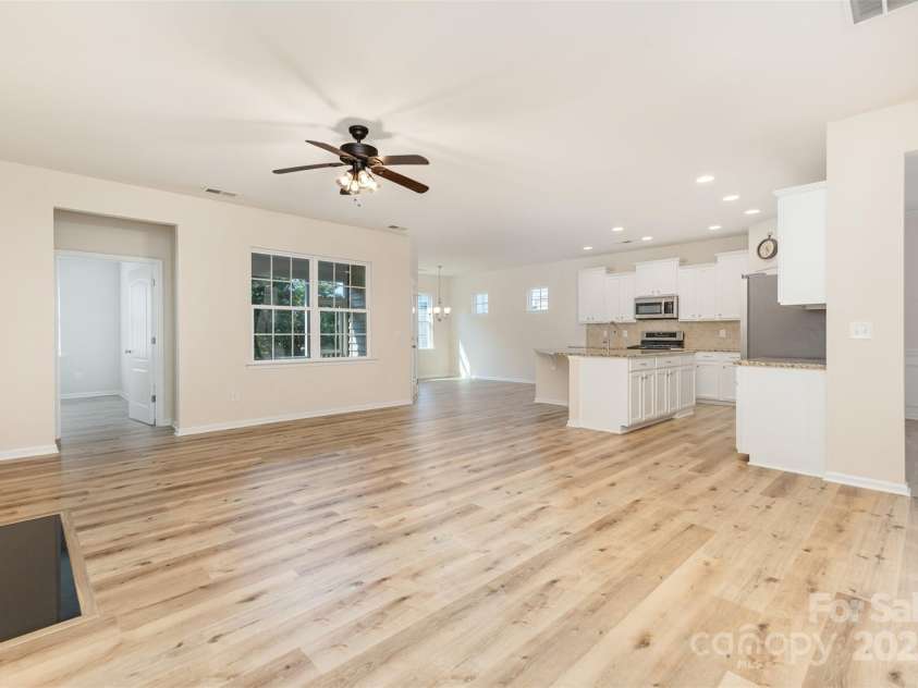 6007 Edinburgh Lane, Fort Mill, SC 29707.  MLS# CAR4295658, YatesRealty ID 34881. The family room and kitchen are open to include everyone when you are entertaining