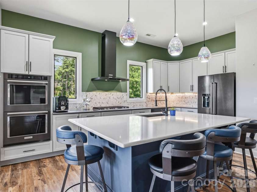 11 Timber Hill Drive, Leicester, NC 28748.  MLS# CAR4395563, YatesRealty ID 34902. Entertaining is easy with the black stainless KitchenAid appliances; including a double oven and 36
