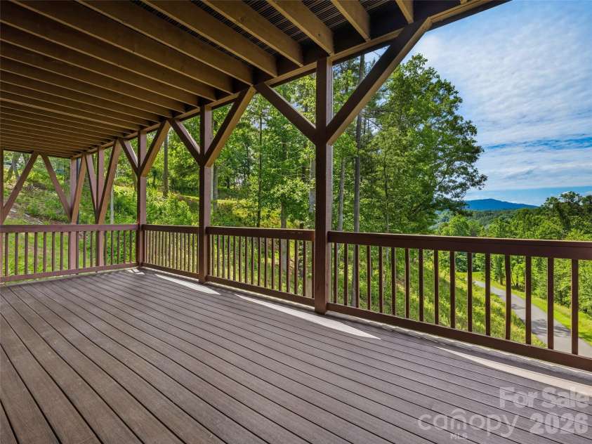 11 Timber Hill Drive, Leicester, NC 28748.  MLS# CAR4395563, YatesRealty ID 34902. Terrace level covered deck with moutain views.