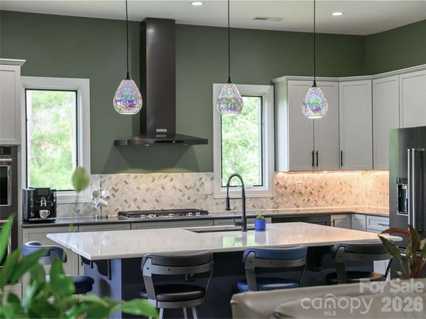 11 Timber Hill Drive, Leicester, NC 28748.  MLS# CAR4395563, YatesRealty ID 34902. The kitchen features a large central island that comfortably seats four.