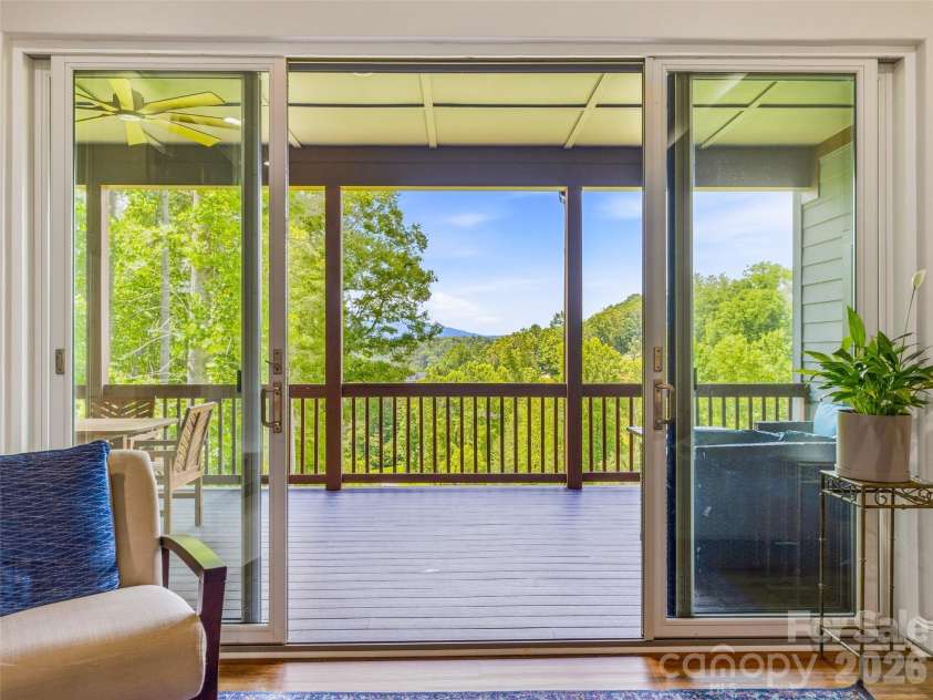 11 Timber Hill Drive, Leicester, NC 28748.  MLS# CAR4395563, YatesRealty ID 34902. The living room flows seamlessly to the expansive covered deck.