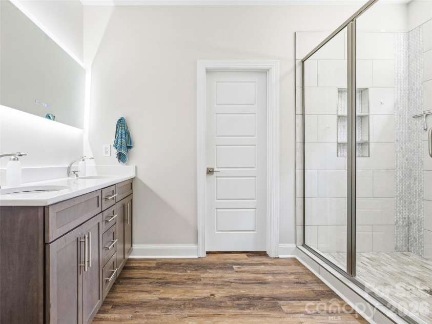 11 Timber Hill Drive, Leicester, NC 28748.  MLS# CAR4395563, YatesRealty ID 34902. The primary ensuite bath features a 5 foot fogless mirror.