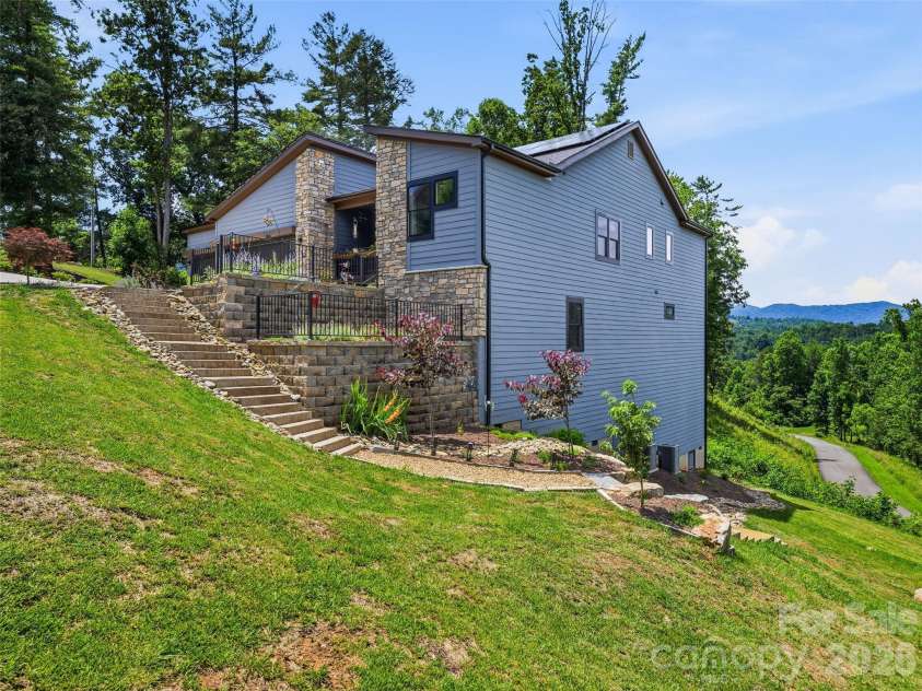 11 Timber Hill Drive, Leicester, NC 28748.  MLS# CAR4395563, YatesRealty ID 34902. This stunning home rests on 1.46 acre with beautiful landscaping.