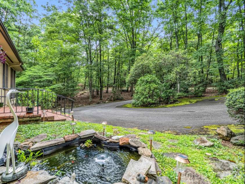 390 Mountain Laurel Drive, Columbus, NC 28722.  MLS# CAR4399139, YatesRealty ID 34904. Water feature greats visitors