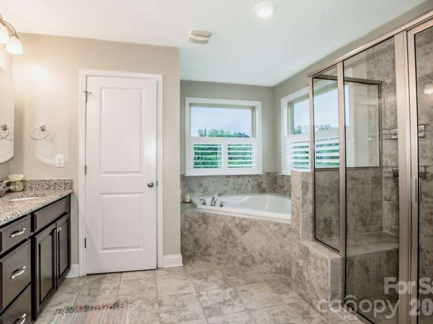 130 Eagles Landing Drive, Mooresville, NC 28117.  MLS# CAR4407110, YatesRealty ID 34907. Beautifully tiled primary bathroom
