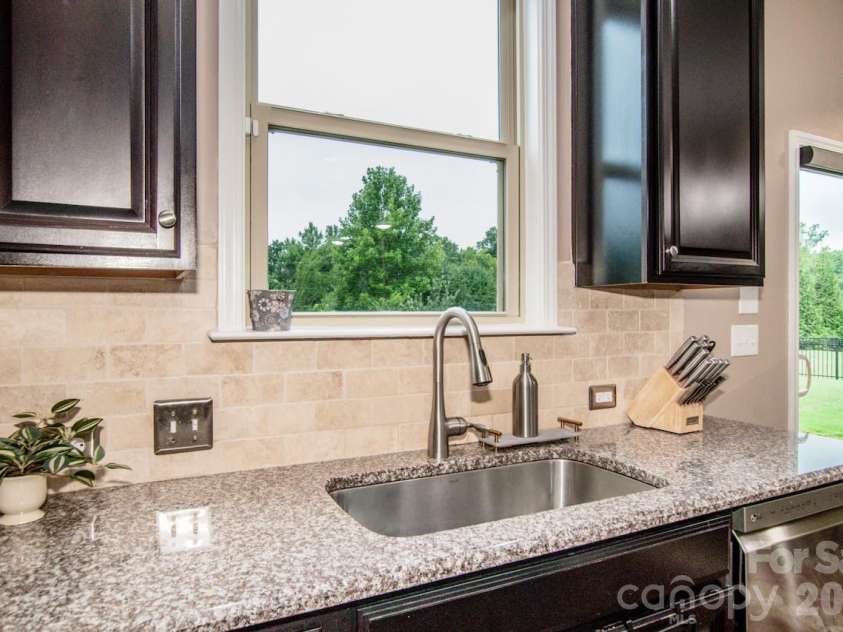 130 Eagles Landing Drive, Mooresville, NC 28117.  MLS# CAR4407110, YatesRealty ID 34907. Wooded views from kitchen sink window