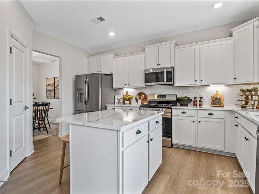 136 Ella Claire Drive, York, SC 29745.  MLS# CAR4187874, YatesRealty ID 3493. PHOTO REPRESENTATION ONLY. Kitchen of decorated model home. Finishes are different than shown. Refer to interior design selections for finishes. Refrigerator not included.