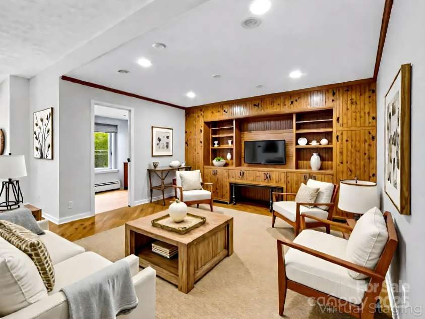 194 Bear Creek Drive, Fletcher, NC 28732.  MLS# CAR4287026, YatesRealty ID 34943. Virtally staged, the downstairs den has a super cozy vibe with all the wood accents and built-ins.