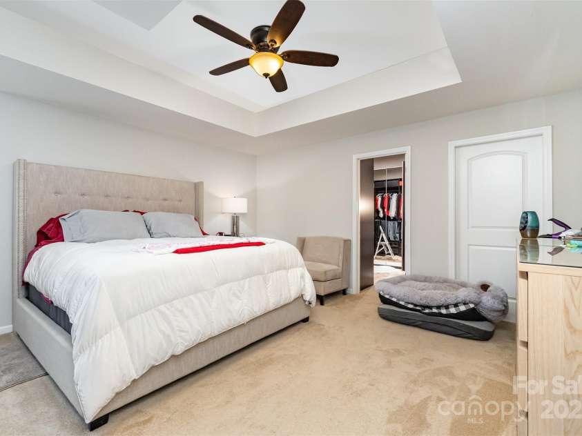 423 Crisfield Court, York, SC 29745.  MLS# CAR4319064, YatesRealty ID 34951. Downstairs primary bedroom with custom shelving in walk-in closet