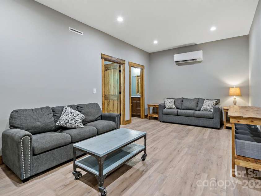 23 Laurel Crest Lane, Mill Spring, NC 28756.  MLS# CAR4294698, YatesRealty ID 34956. 2nd living room in basement