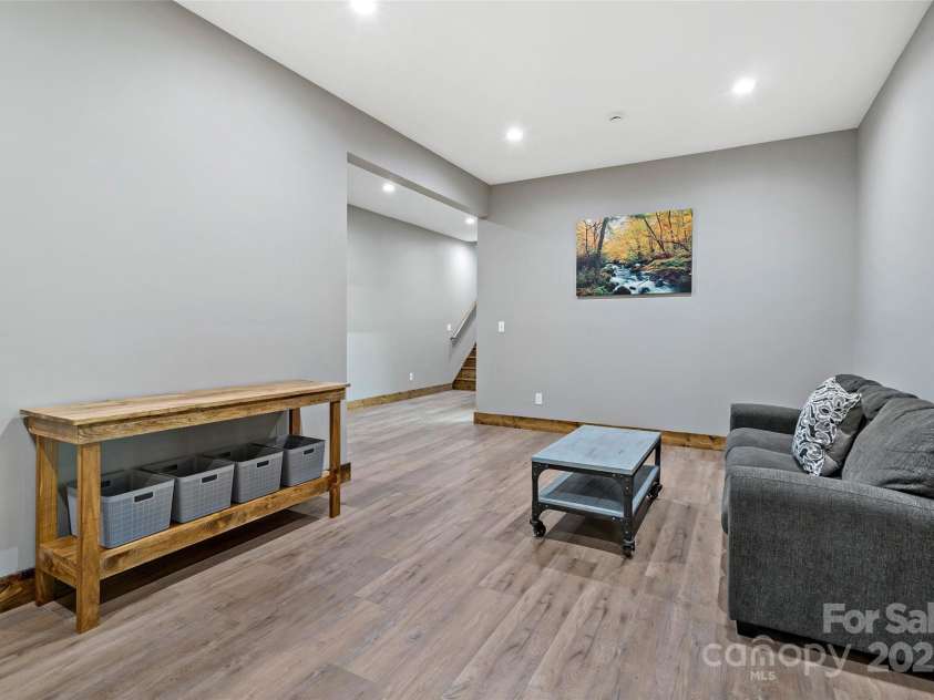 23 Laurel Crest Lane, Mill Spring, NC 28756.  MLS# CAR4294698, YatesRealty ID 34956. 2nd living room in basement