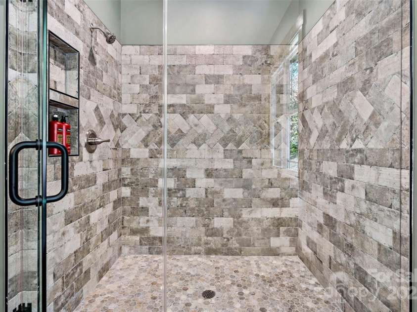 23 Laurel Crest Lane, Mill Spring, NC 28756.  MLS# CAR4294698, YatesRealty ID 34956. Beautiful tiled shower