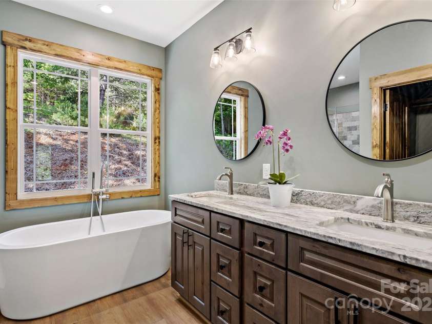 23 Laurel Crest Lane, Mill Spring, NC 28756.  MLS# CAR4294698, YatesRealty ID 34956. Double vanity and soaker tub