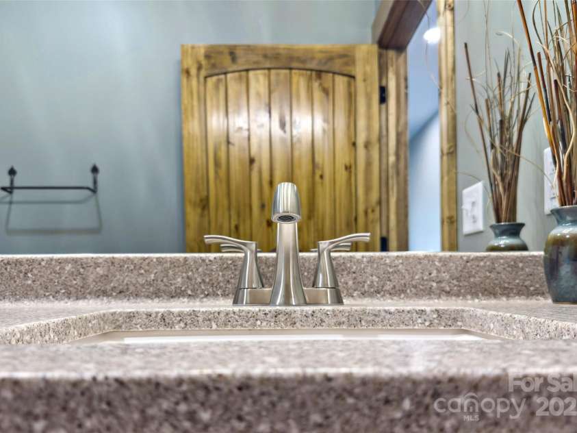 23 Laurel Crest Lane, Mill Spring, NC 28756.  MLS# CAR4294698, YatesRealty ID 34956. Guest bathroom on main level